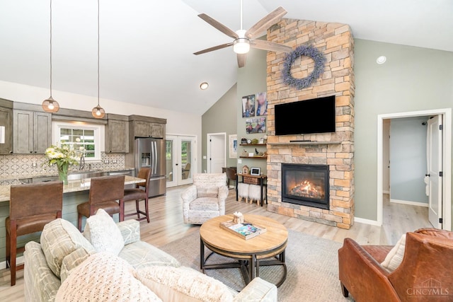 3008 State Route 133, Bethel, OH 45106 - living area featuring high vaulted ceiling, ceiling fan, a fireplace, and light wood-style flooring