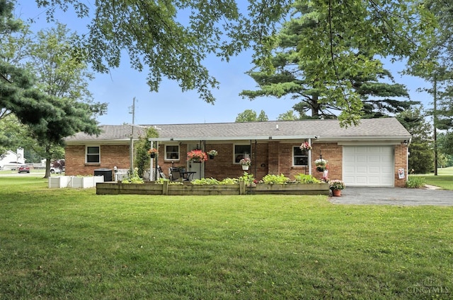 8135 Faller Rd, Hamilton Twp, OH 45039 - ranch-style home featuring an attached garage, brick siding, a front lawn, and asphalt driveway
