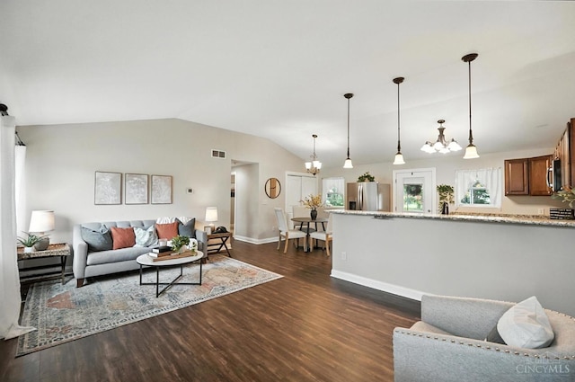 8135 Faller Rd, Hamilton Twp, OH 45039 - living area with dark wood finished floors, vaulted ceiling, and a chandelier