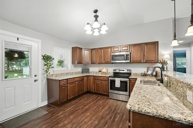 8135 Faller Rd, Hamilton Twp, OH 45039 - kitchen featuring appliances with stainless steel finishes, dark wood-style flooring, a chandelier, lofted ceiling, and light stone counters