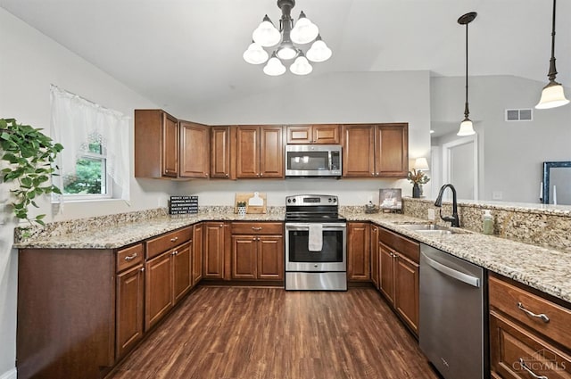 8135 Faller Rd, Hamilton Twp, OH 45039 - kitchen with stainless steel appliances, vaulted ceiling, dark wood-style flooring, a chandelier, and light stone counters