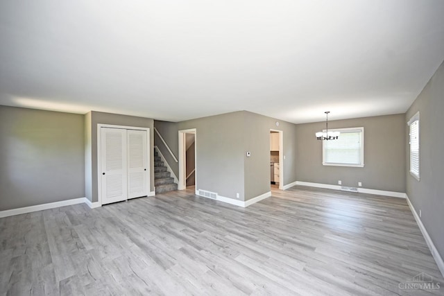 64 Craig Dr, Hamilton, OH 45013 - unfurnished room with a chandelier, stairs, and light wood-style floors