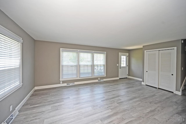 64 Craig Dr, Hamilton, OH 45013 - unfurnished living room featuring healthy amount of natural light and wood finished floors