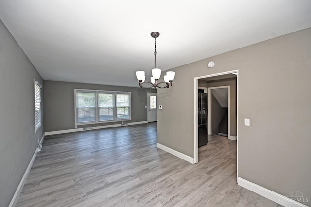 64 Craig Dr, Hamilton, OH 45013 - spare room with a chandelier, wood finished floors, and a smoke detector