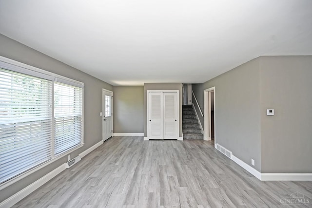 64 Craig Dr, Hamilton, OH 45013 - unfurnished living room with stairway and light wood-style flooring