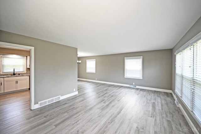 64 Craig Dr, Hamilton, OH 45013 - spare room featuring a sink and light wood-style flooring