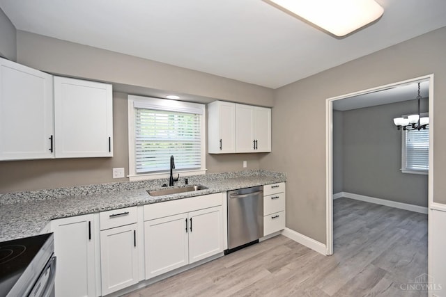 64 Craig Dr, Hamilton, OH 45013 - kitchen with appliances with stainless steel finishes, light wood finished floors, white cabinets, a chandelier, and light stone counters