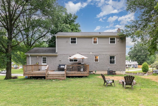 3340 Algus Ln, Green Twp, OH 45248 - rear view of house with a chimney, brick siding, a lawn, and a wooden deck