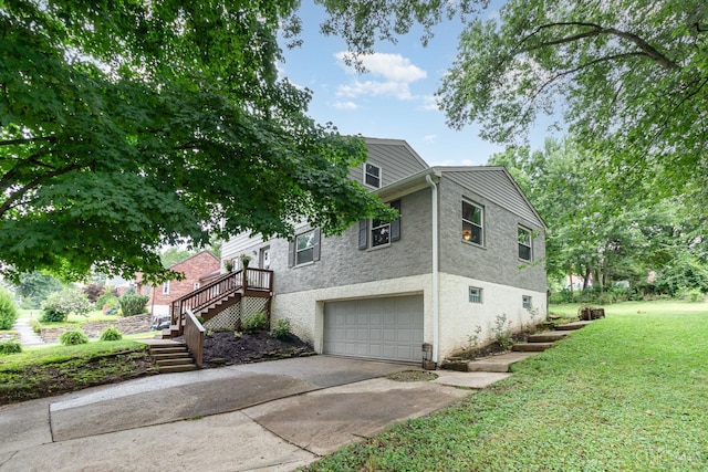 3340 Algus Ln, Green Twp, OH 45248 - view of side of property with concrete driveway, a garage, stairway, and a lawn