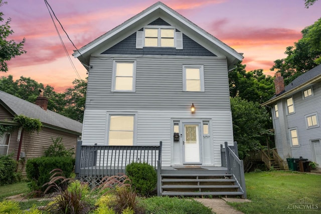 5824 Saranac Ave, Cincinnati, OH 45224 - view of front of home with a lawn and a deck