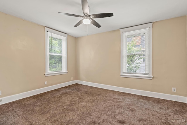 5824 Saranac Ave, Cincinnati, OH 45224 - spare room with healthy amount of natural light, dark colored carpet, and a ceiling fan