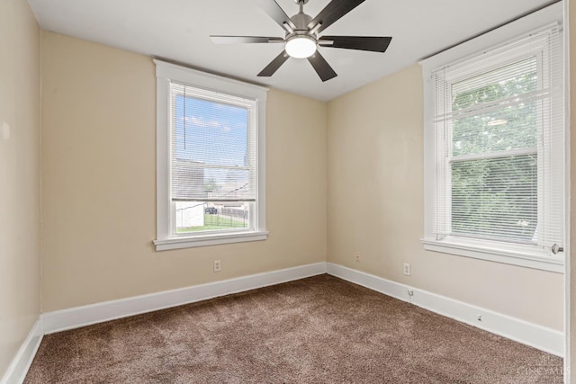 5824 Saranac Ave, Cincinnati, OH 45224 - empty room featuring dark colored carpet, healthy amount of natural light, and ceiling fan