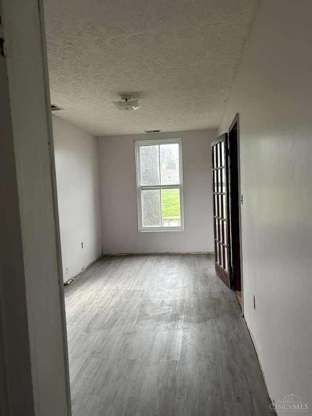 202 E 2nd St, Georgetown, OH 45121 - empty room featuring wood finished floors and a textured ceiling