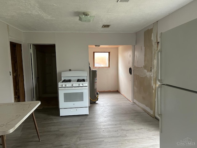 202 E 2nd St, Georgetown, OH 45121 - kitchen featuring white appliances, a textured ceiling, and wood finished floors
