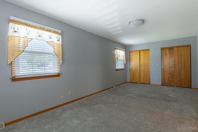 27 N Breiel, Middletown, OH 45042 - unfurnished bedroom featuring two closets and carpet flooring