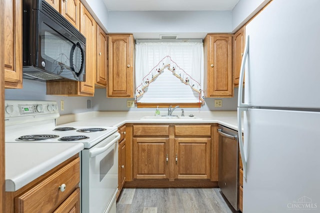 27 N Breiel, Middletown, OH 45042 - kitchen featuring white appliances, light wood finished floors, brown cabinetry, and light countertops