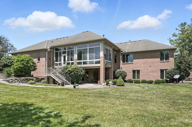 4994 Maxwell Dr, Mason, OH 45040 - rear view of house featuring a sunroom, a patio, brick siding, a yard, and stairway