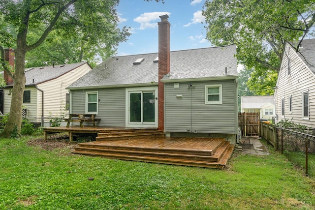 6846 Bryn Mawr Dr, Springfield Twp, OH 45224 - back of property with a fenced backyard, a deck, a chimney, and a shingled roof