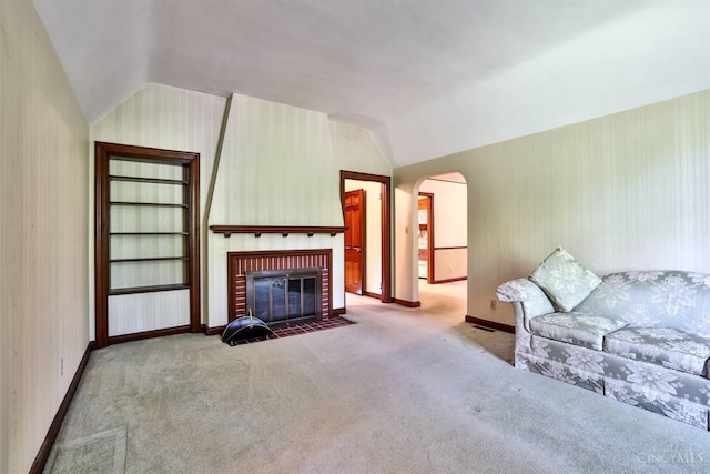 5868 Greenlawn Rd, Fairfield Twp, OH 45011 - carpeted living area with vaulted ceiling, arched walkways, and a fireplace