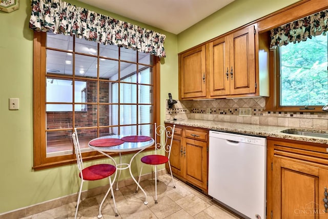 5868 Greenlawn Rd, Fairfield Twp, OH 45011 - kitchen with white dishwasher, brown cabinets, decorative backsplash, and light stone counters