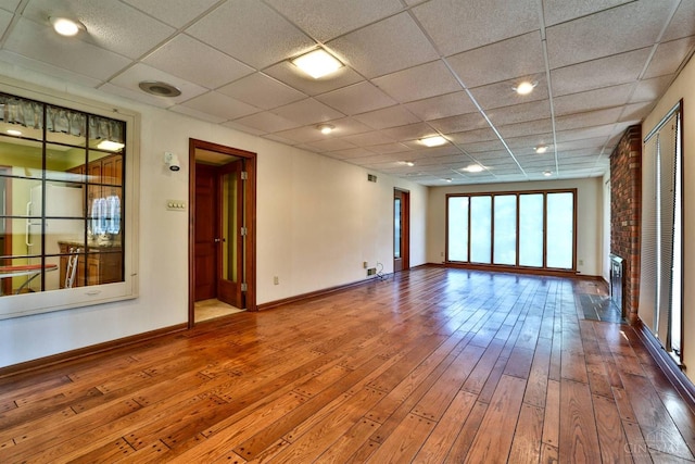 5868 Greenlawn Rd, Fairfield Twp, OH 45011 - spare room with hardwood / wood-style floors, a paneled ceiling, and a fireplace