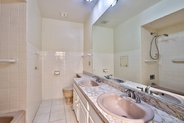 5868 Greenlawn Rd, Fairfield Twp, OH 45011 - full bath featuring tile walls, tile patterned flooring, double vanity,  shower combination, and a wainscoted wall