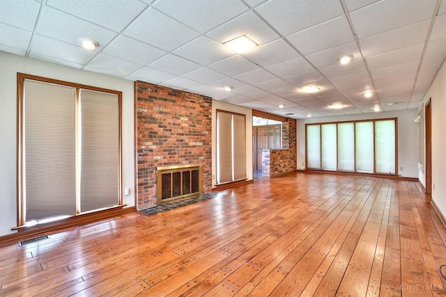 5868 Greenlawn Rd, Fairfield Twp, OH 45011 - unfurnished living room with light wood finished floors, a paneled ceiling, and a fireplace