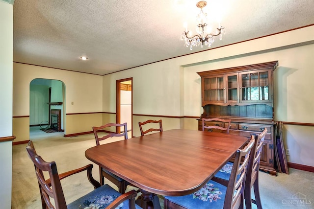 5868 Greenlawn Rd, Fairfield Twp, OH 45011 - carpeted dining room with arched walkways, a textured ceiling, and a chandelier