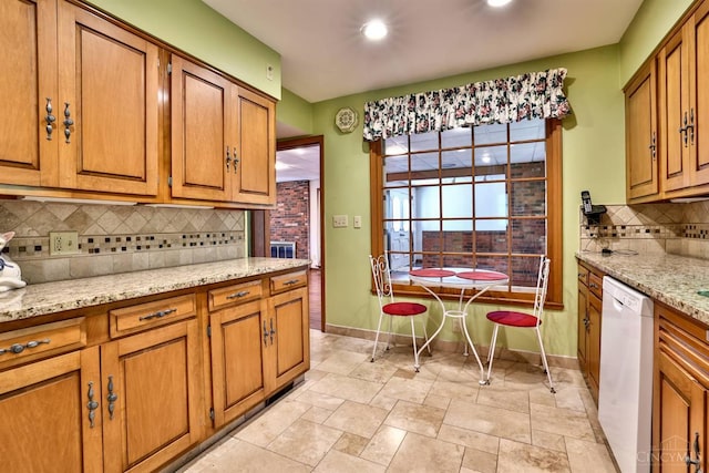 5868 Greenlawn Rd, Fairfield Twp, OH 45011 - kitchen featuring white dishwasher, brown cabinetry, light stone finish flooring, and recessed lighting