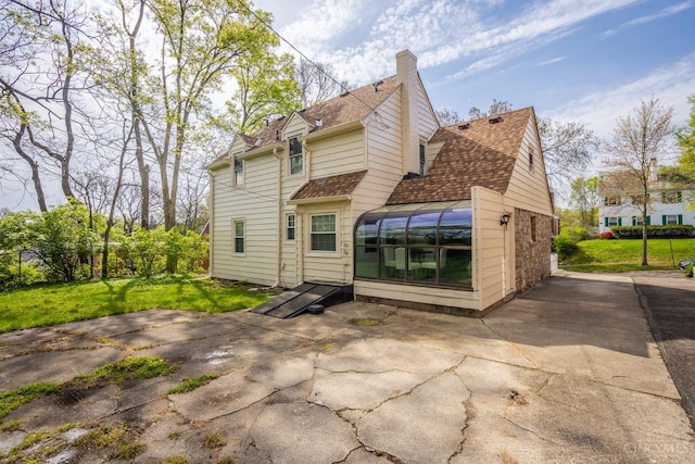 1744 Northampton Dr, Cincinnati, OH 45237 - rear view of property with a chimney, roof with shingles, a patio, and a lawn