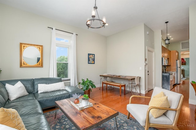 2100 Sinton Ave Unit 2, Cincinnati, OH 45206 - living area featuring wood finished floors and a chandelier