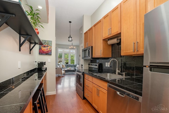 2100 Sinton Ave Unit 2, Cincinnati, OH 45206 - kitchen with stainless steel appliances, backsplash, light wood-style floors, hanging light fixtures, and recessed lighting