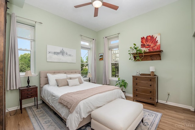 2100 Sinton Ave Unit 2, Cincinnati, OH 45206 - bedroom with multiple windows, light wood-type flooring, and a ceiling fan