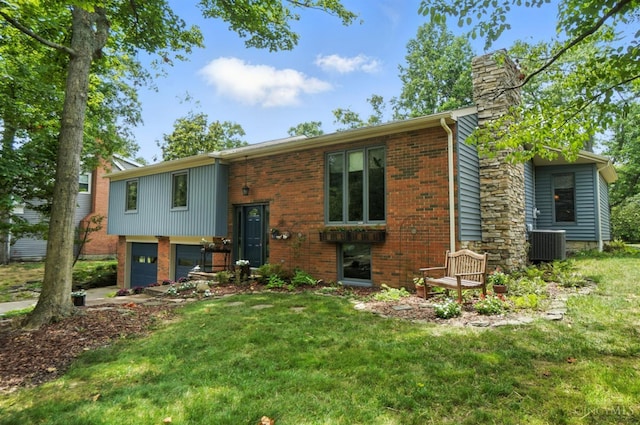 1092 Fox Run Rd, Miami Twp, OH 45150 - back of house featuring a chimney, brick siding, an attached garage, and a yard