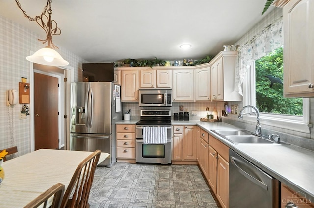 1092 Fox Run Rd, Miami Twp, OH 45150 - kitchen with stainless steel appliances, light countertops, hanging light fixtures, backsplash, and wallpapered walls