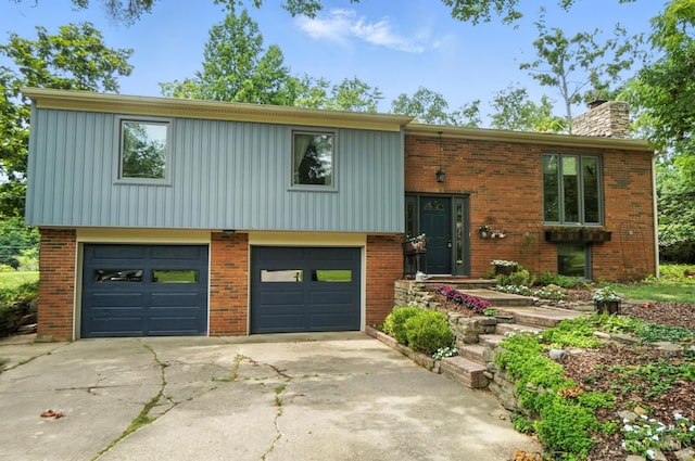 1092 Fox Run Rd, Miami Twp, OH 45150 - split foyer home with an attached garage, a chimney, and brick siding