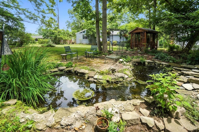 1092 Fox Run Rd, Miami Twp, OH 45150 - view of green lawn with a small pond and an outdoor structure