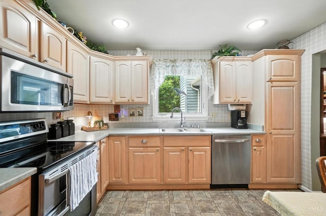 1092 Fox Run Rd, Miami Twp, OH 45150 - kitchen with appliances with stainless steel finishes, light countertops, backsplash, and light brown cabinetry