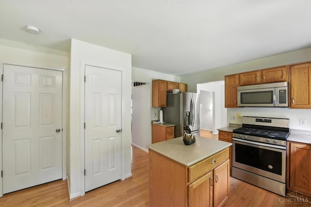 8538 Sunmont Dr, Anderson Twp, OH 45255 - kitchen featuring stainless steel appliances, light wood-style flooring, light countertops, and brown cabinets
