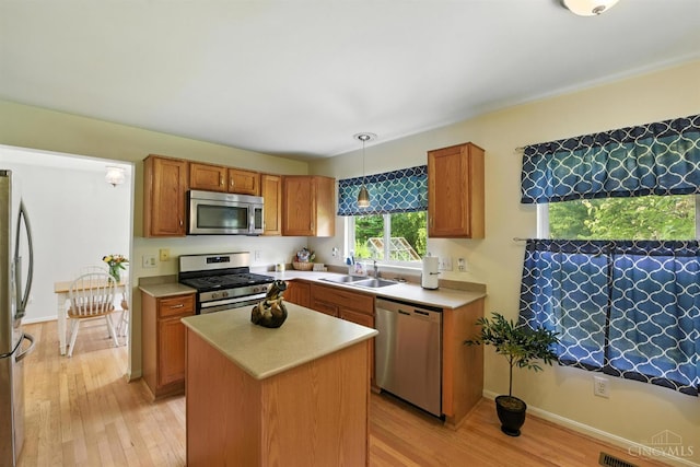 8538 Sunmont Dr, Anderson Twp, OH 45255 - kitchen with stainless steel appliances, light wood finished floors, light countertops, and pendant lighting