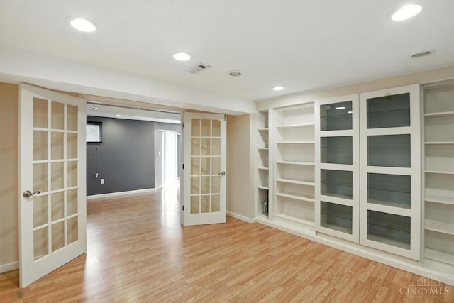 2317 Garrison Dr, Springfield Twp, OH 45231 - empty room with french doors, wood finished floors, recessed lighting, and built in shelves