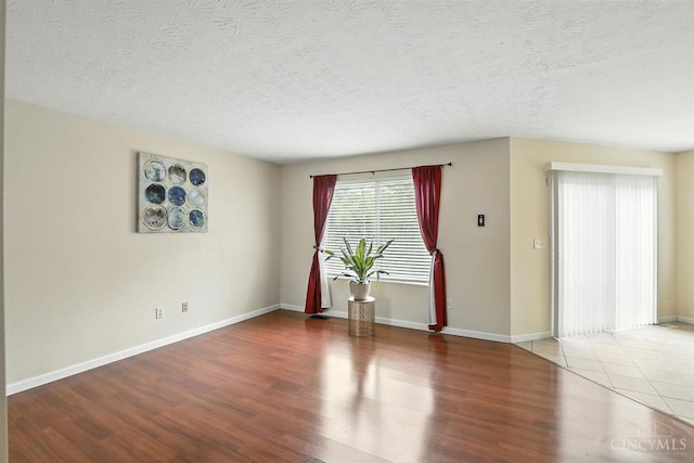 2317 Garrison Dr, Springfield Twp, OH 45231 - empty room with wood finished floors and a textured ceiling