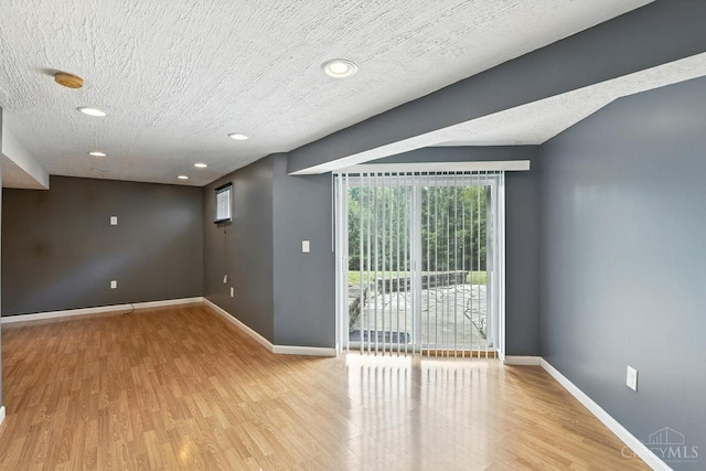 2317 Garrison Dr, Springfield Twp, OH 45231 - unfurnished room featuring a smoke detector, wood finished floors, a textured ceiling, and recessed lighting