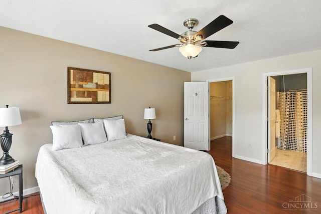 2317 Garrison Dr, Springfield Twp, OH 45231 - bedroom with wood finished floors, a spacious closet, a ceiling fan, and ensuite bathroom