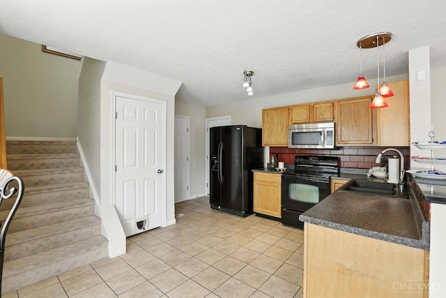 2317 Garrison Dr, Springfield Twp, OH 45231 - kitchen with black appliances, dark countertops, light tile patterned floors, backsplash, and decorative light fixtures