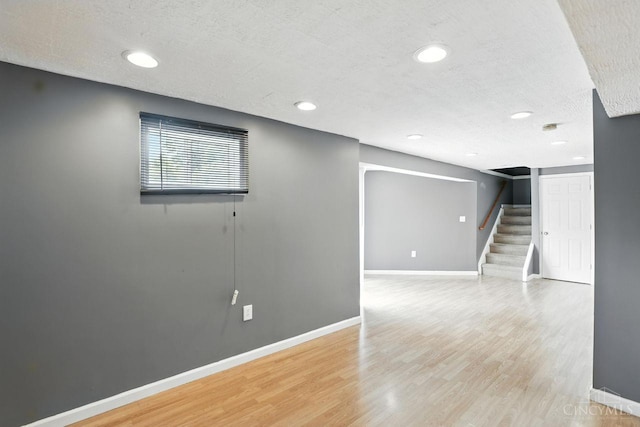 2317 Garrison Dr, Springfield Twp, OH 45231 - basement featuring light wood-style floors, stairs, recessed lighting, and a textured ceiling