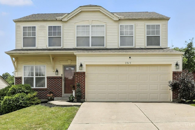 2317 Garrison Dr, Springfield Twp, OH 45231 - traditional-style house with brick siding, concrete driveway, and an attached garage