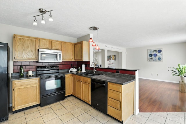 2317 Garrison Dr, Springfield Twp, OH 45231 - kitchen with black appliances, a peninsula, dark countertops, light tile patterned floors, and a textured ceiling