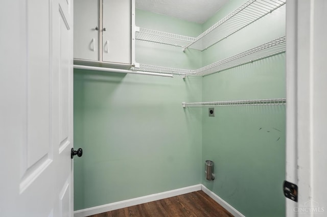 8939 Perry Ave, Franklin, OH 45005 - washroom with electric dryer hookup, cabinet space, and dark wood-style floors