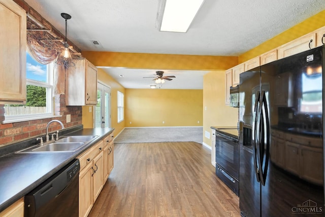 8939 Perry Ave, Franklin, OH 45005 - kitchen with black appliances, dark countertops, wood finished floors, open floor plan, and light brown cabinets